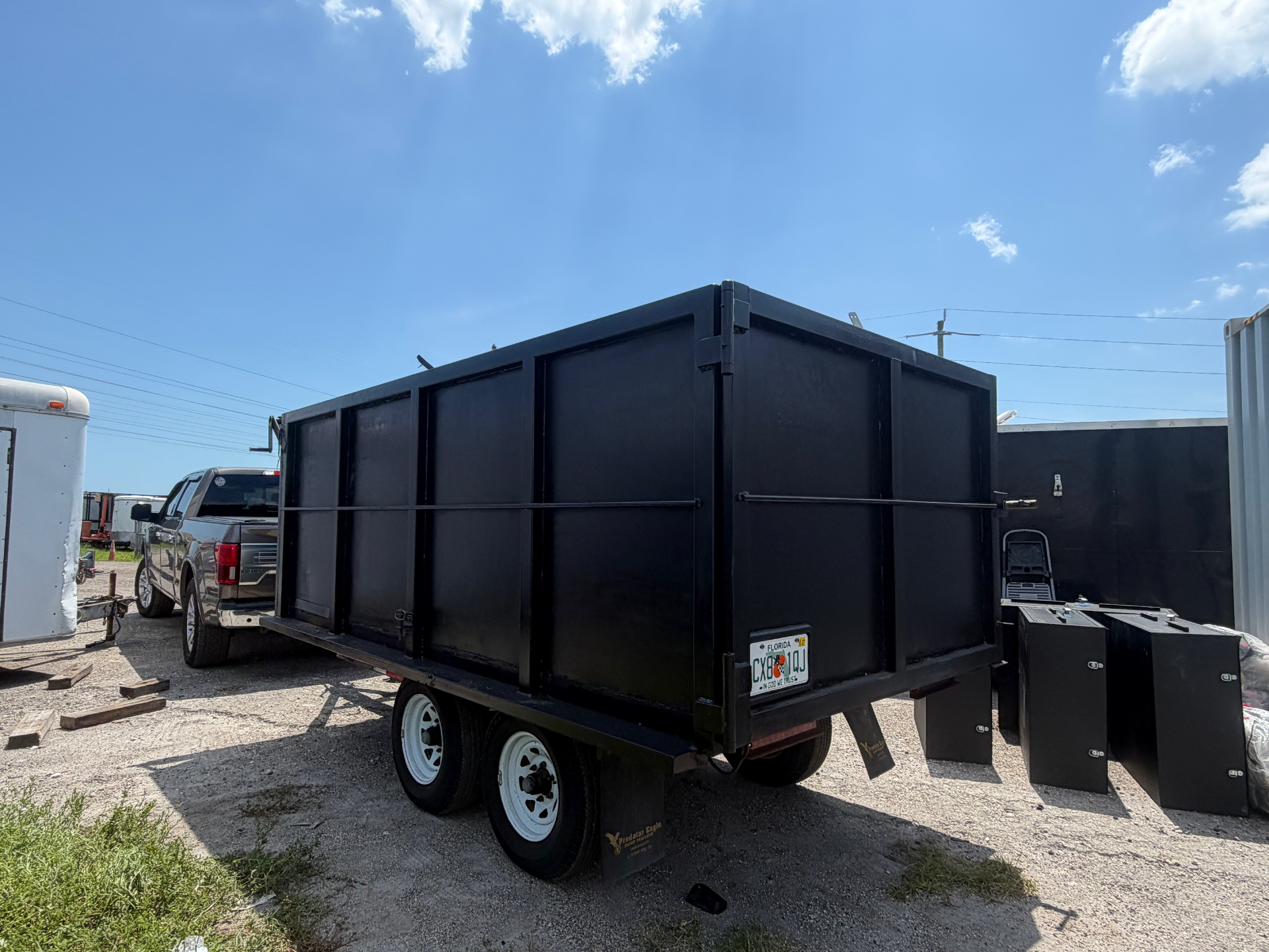 Miller Property Services dump trailer hitched to truck ready for job
